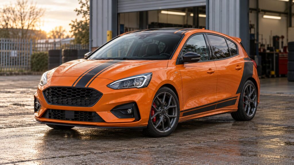 Orange Ford Focus ST with black motorsport graphics outside a vehicle workshop